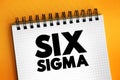 Six Sigma 6ÃÆ - set of techniques and tools for process improvement, text concept on notepad